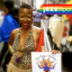 The author at NYC Pride 2011 holding her Aunt Betty’s Basement sign